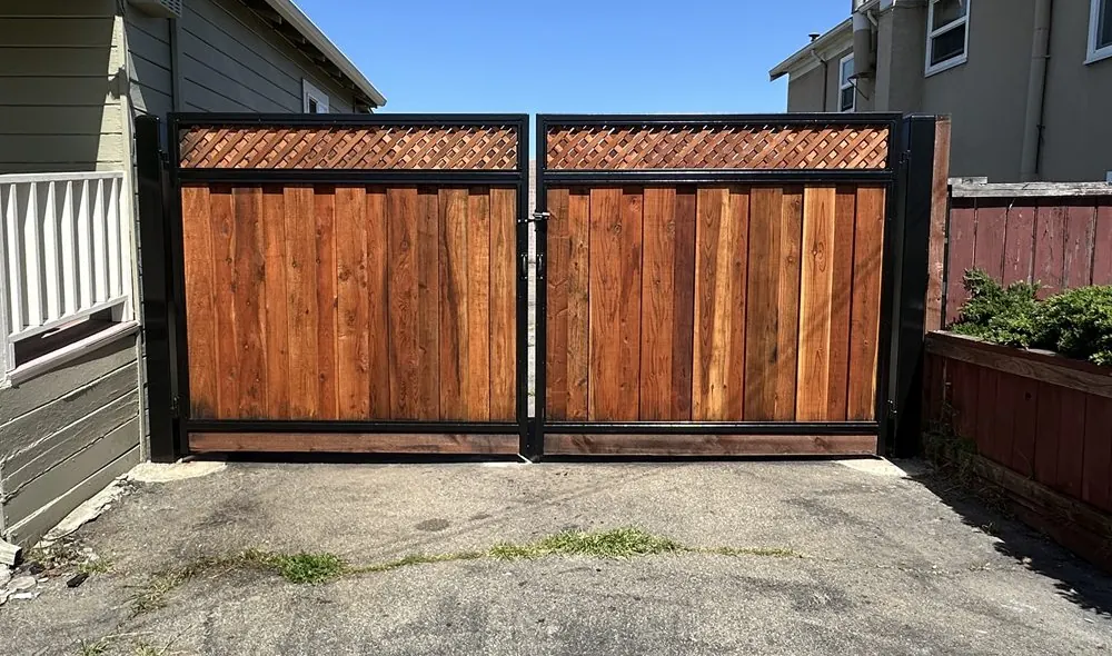 Two wood gate leaves with steel frames and lattice tops