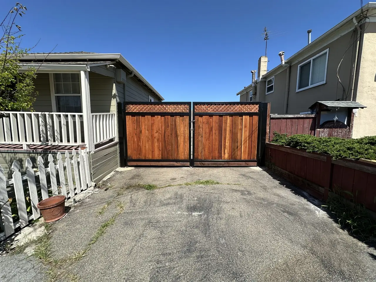 Wood driveway gate panels framed in black steel