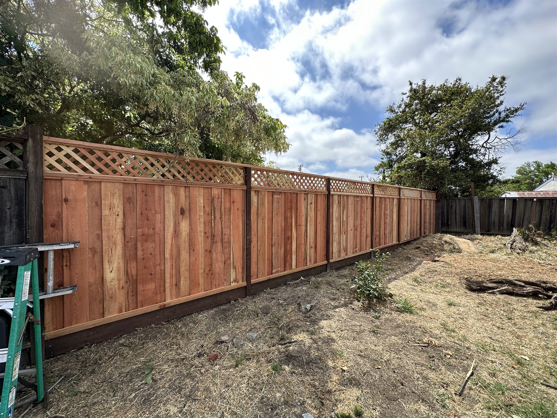 Finished wood privacy fence with lattice top