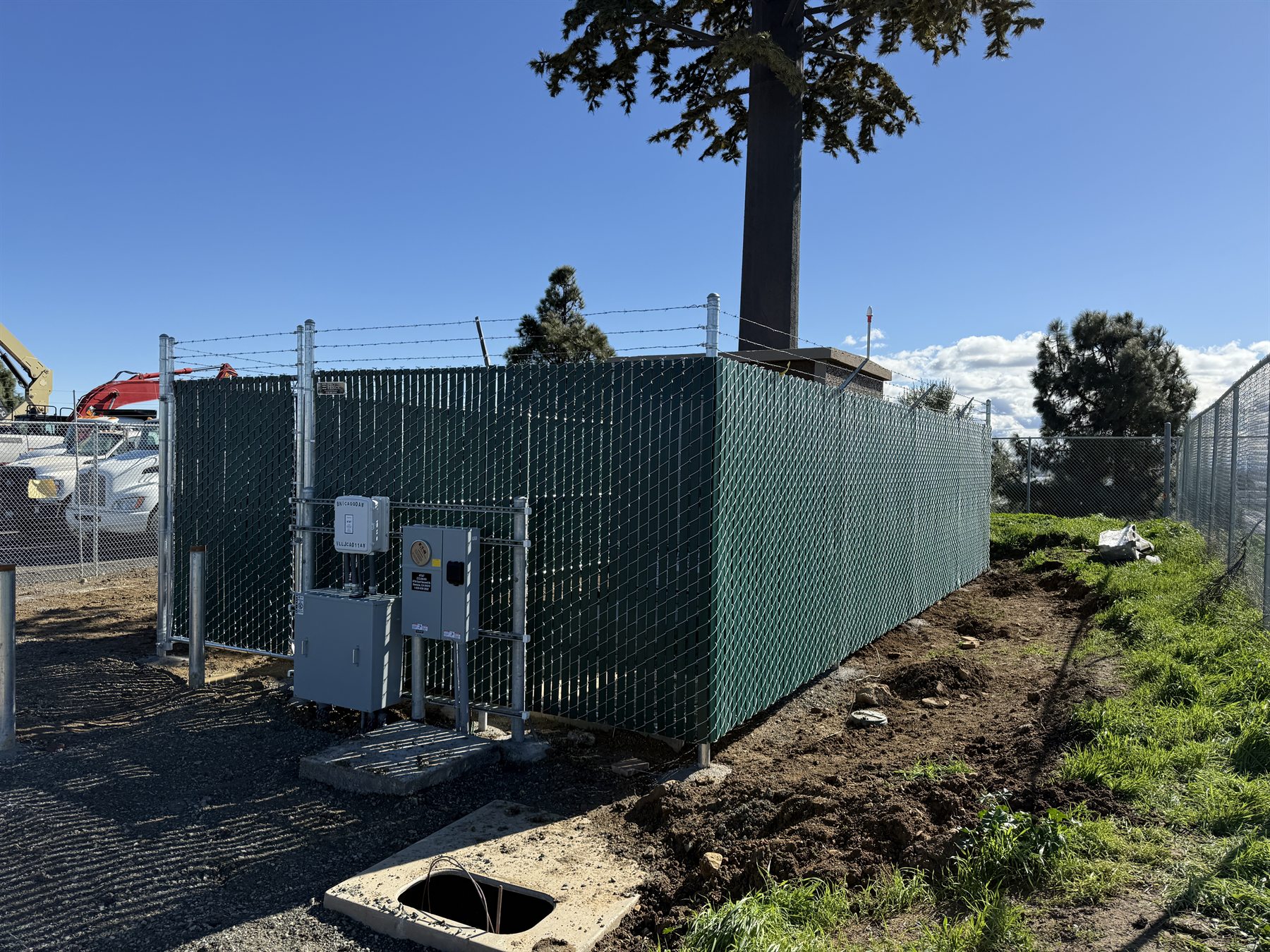 Screened chain link utility enclosure